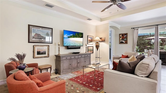 11625 Parrotfish St, Venice, FL 34292 - living area with baseboards, ornamental molding, arched walkways, a ceiling fan, and a tray ceiling