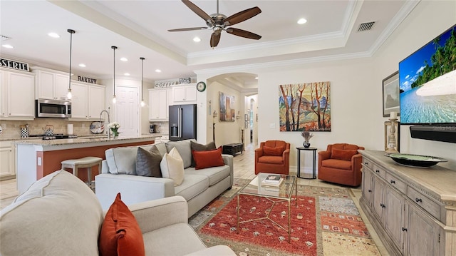 11625 Parrotfish St, Venice, FL 34292 - living area featuring ceiling fan, arched walkways, recessed lighting, crown molding, and baseboards