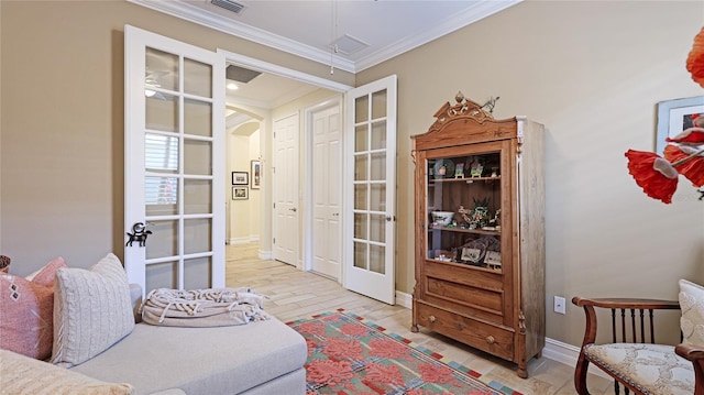 11625 Parrotfish St, Venice, FL 34292 - sitting room featuring french doors, arched walkways, attic access, crown molding, and baseboards
