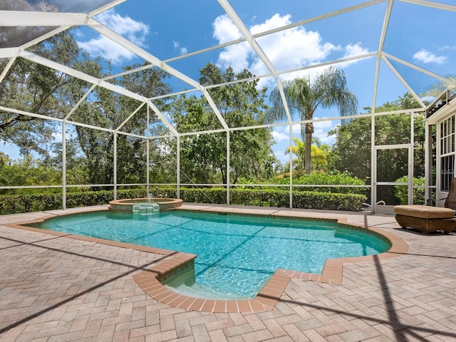 7003 Lancaster Ct, University Park, FL 34201 - view of swimming pool featuring a patio, a pool with connected hot tub, glass enclosure, and view of scattered trees