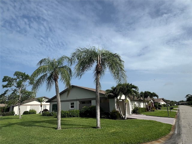 3752 Collins St Unit 508, Sarasota, FL 34232 - view of side of home with a lawn, driveway, and stucco siding