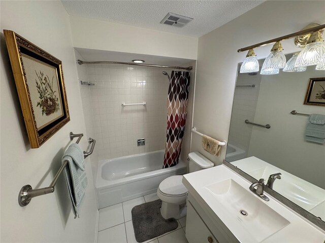 3752 Collins St Unit 508, Sarasota, FL 34232 - bathroom featuring toilet, tile patterned flooring, shower / bath combo with shower curtain, vanity, and a textured ceiling