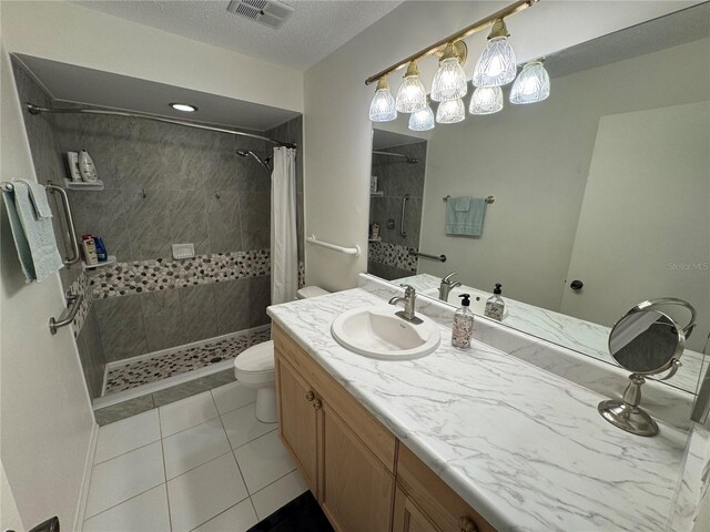 3752 Collins St Unit 508, Sarasota, FL 34232 - full bath with toilet, tiled shower, vanity, tile patterned floors, and a textured ceiling