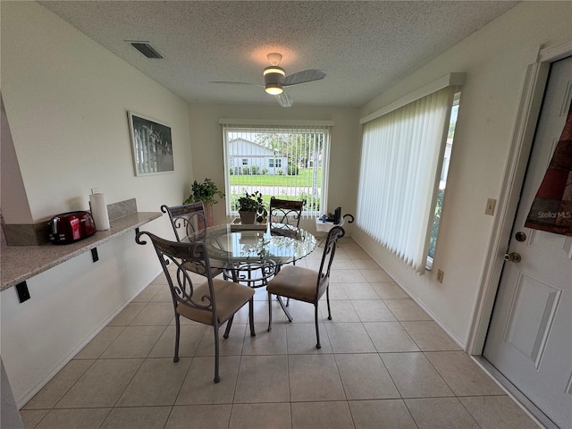 3752 Collins St Unit 508, Sarasota, FL 34232 - dining space with a textured ceiling, a ceiling fan, and light tile patterned flooring