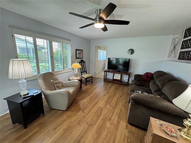 3752 Collins St Unit 508, Sarasota, FL 34232 - living area featuring a textured ceiling, light wood-style floors, and a ceiling fan