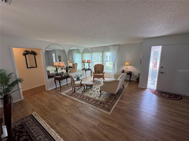 3752 Collins St Unit 508, Sarasota, FL 34232 - living room featuring a textured ceiling, wood finished floors, healthy amount of natural light, and baseboards