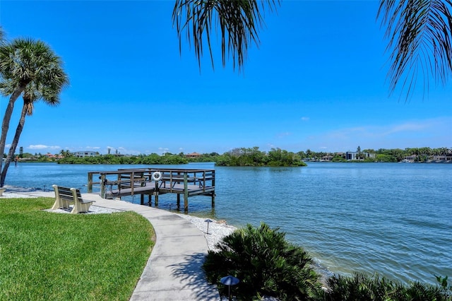 1350 N Portofino Dr Unit 402, Sarasota, FL 34242 - dock area featuring a water view and a lawn