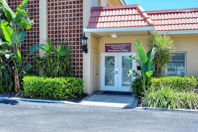 1350 N Portofino Dr Unit 402, Sarasota, FL 34242 - property entrance with french doors and stucco siding