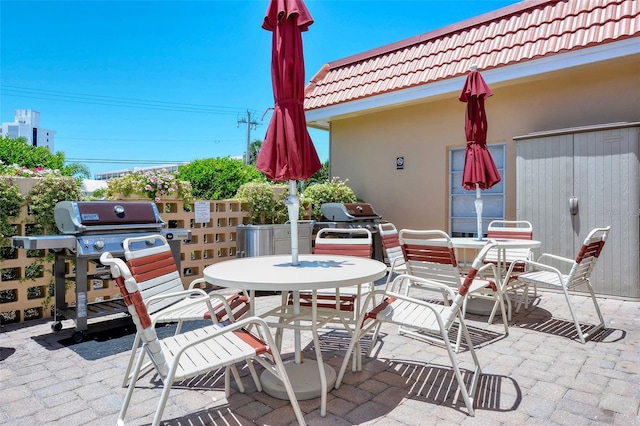 1350 N Portofino Dr Unit 402, Sarasota, FL 34242 - view of patio featuring outdoor dining space and grilling area