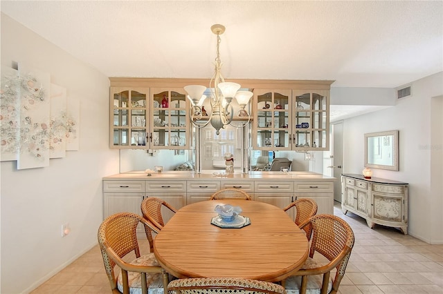1350 N Portofino Dr Unit 402, Sarasota, FL 34242 - dining space with a chandelier and light tile patterned floors