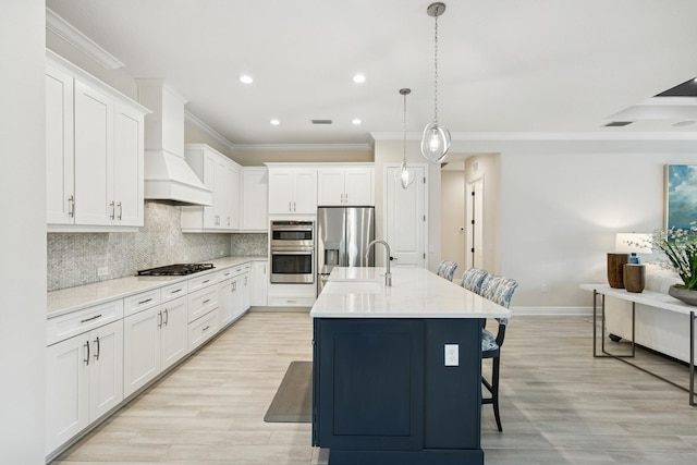 13606 Deep Blue Pl, Bradenton, FL 34211 - kitchen with appliances with stainless steel finishes, ornamental molding, custom range hood, a kitchen bar, and tasteful backsplash