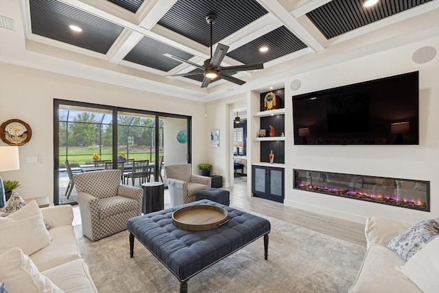 13606 Deep Blue Pl, Bradenton, FL 34211 - living room featuring ornamental molding, coffered ceiling, a glass covered fireplace, ceiling fan, and beam ceiling