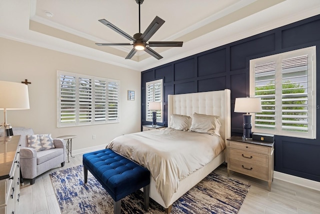13606 Deep Blue Pl, Bradenton, FL 34211 - bedroom featuring baseboards, ornamental molding, a raised ceiling, light wood-style flooring, and a ceiling fan