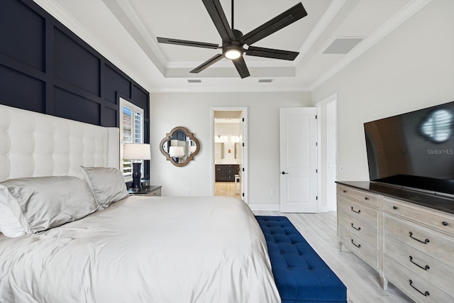 13606 Deep Blue Pl, Bradenton, FL 34211 - bedroom featuring a tray ceiling, ornamental molding, light wood-style floors, ensuite bath, and ceiling fan