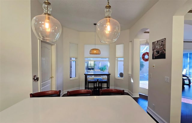 303 9th Ave E, Palmetto, FL 34221 - dining space with wood finished floors, arched walkways, and baseboards