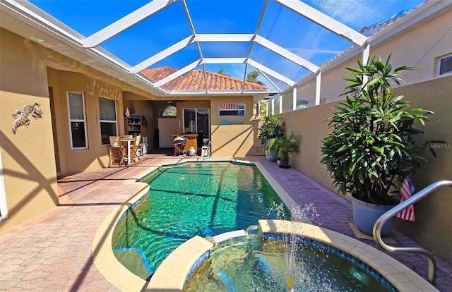 303 9th Ave E, Palmetto, FL 34221 - view of pool featuring a patio, a pool with connected hot tub, and glass enclosure