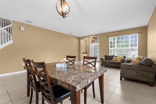 5981 Willows Bridge Loop, Ellenton, FL 34222 - dining space featuring arched walkways, light tile patterned floors, a chandelier, and baseboards