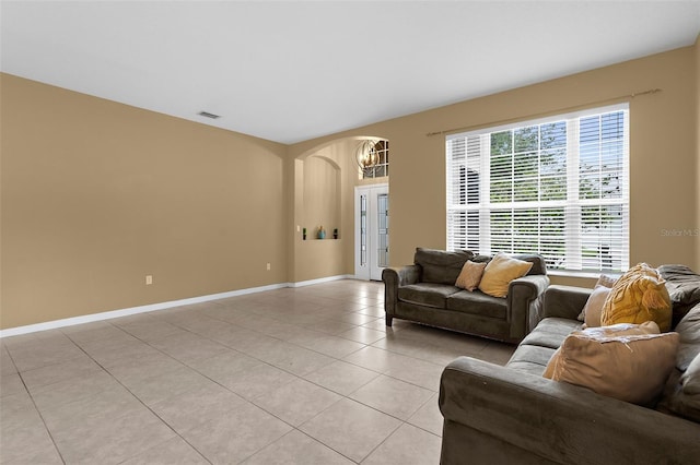 5981 Willows Bridge Loop, Ellenton, FL 34222 - living room featuring arched walkways, light tile patterned floors, baseboards, and a chandelier