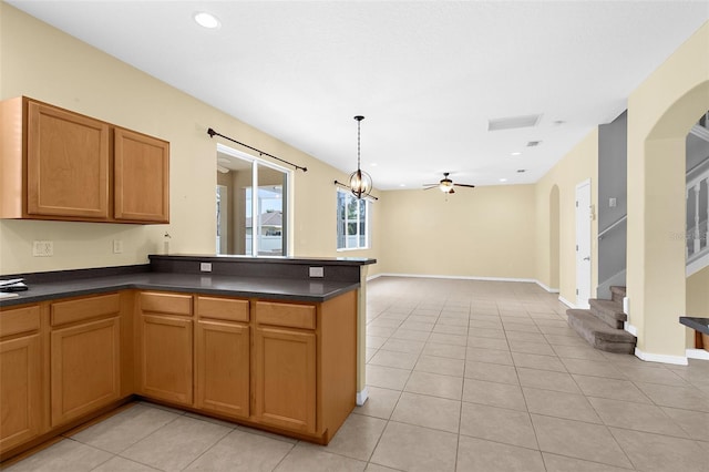5981 Willows Bridge Loop, Ellenton, FL 34222 - kitchen featuring dark countertops, light tile patterned floors, a peninsula, and recessed lighting