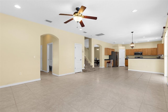 5981 Willows Bridge Loop, Ellenton, FL 34222 - unfurnished living room with arched walkways, a ceiling fan, recessed lighting, baseboards, and light tile patterned floors