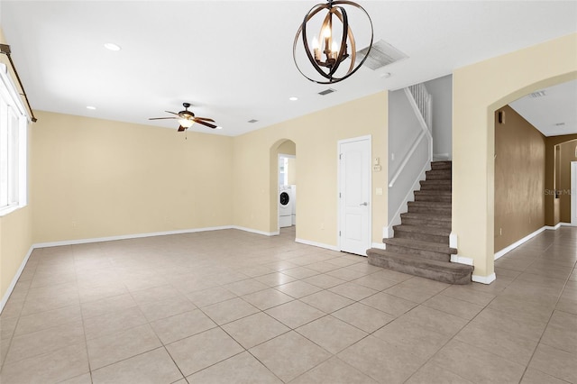 5981 Willows Bridge Loop, Ellenton, FL 34222 - unfurnished living room featuring light tile patterned floors, a ceiling fan, arched walkways, stairway, and washer / dryer