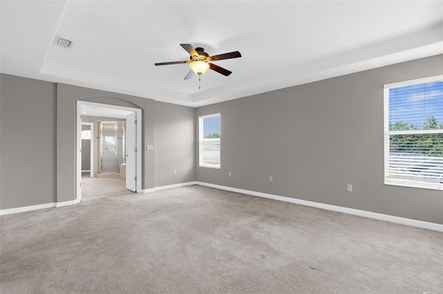 5981 Willows Bridge Loop, Ellenton, FL 34222 - empty room with a raised ceiling, ceiling fan, light colored carpet, arched walkways, and baseboards