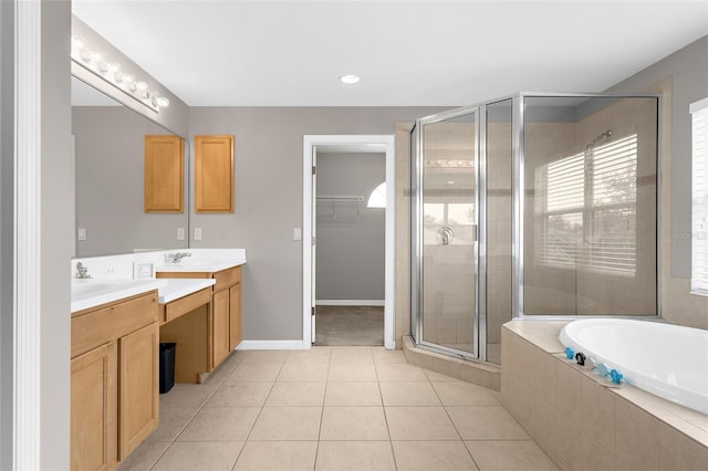 5981 Willows Bridge Loop, Ellenton, FL 34222 - full bathroom with double vanity, a shower stall, a garden tub, a walk in closet, and tile patterned floors