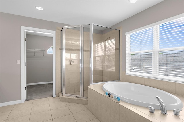 5981 Willows Bridge Loop, Ellenton, FL 34222 - full bathroom featuring a shower stall, a bath, a walk in closet, tile patterned floors, and baseboards