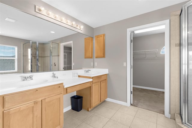 5981 Willows Bridge Loop, Ellenton, FL 34222 - full bathroom featuring a walk in closet, double vanity, a stall shower, and tile patterned floors