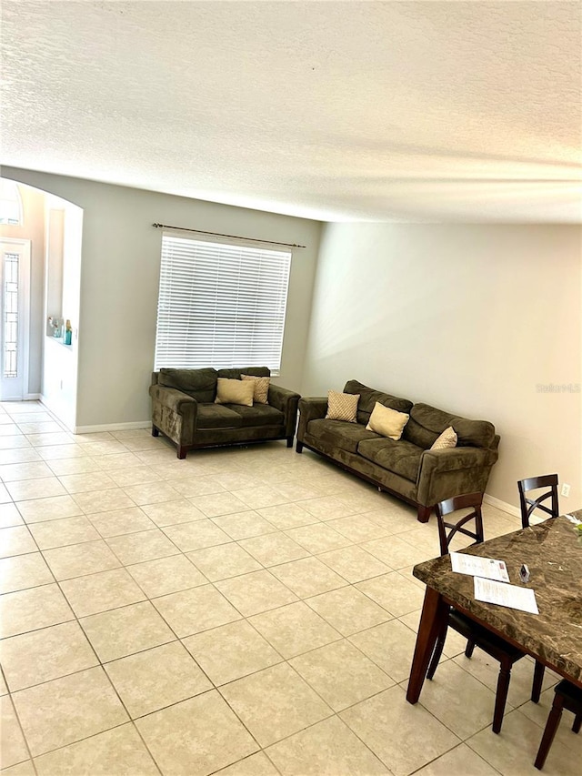 5981 Willows Bridge Loop, Ellenton, FL 34222 - living room featuring a textured ceiling, light tile patterned floors, and an AC wall unit