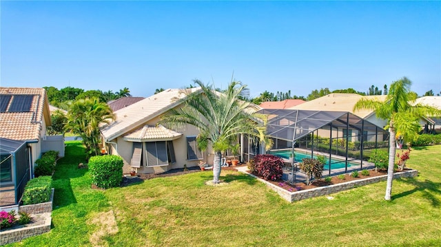105 Inlets Blvd Unit 105, Nokomis, FL 34275 - rear view of house with a yard, an outdoor pool, stucco siding, and a lanai