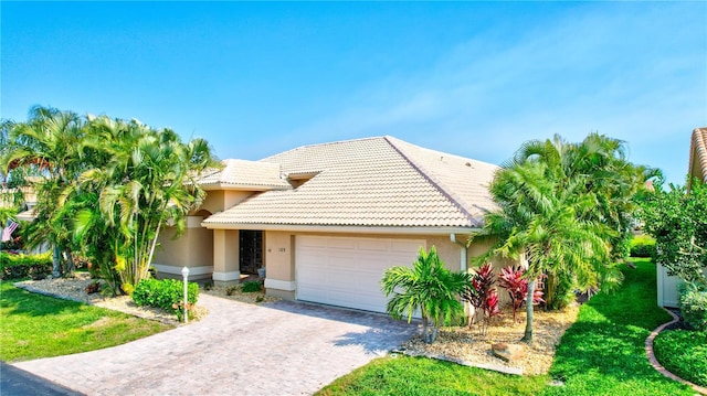 105 Inlets Blvd Unit 105, Nokomis, FL 34275 - view of front facade featuring an attached garage, a tile roof, decorative driveway, and stucco siding