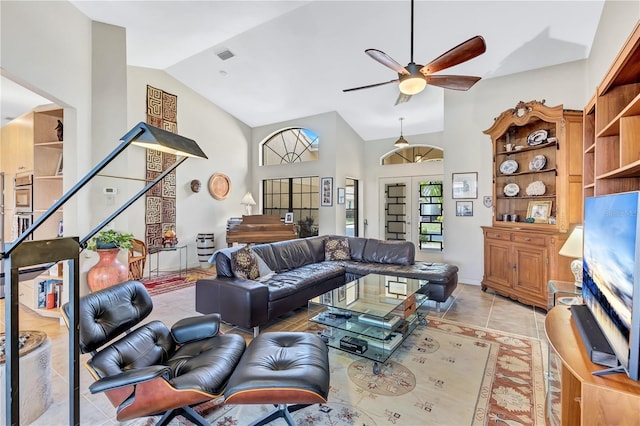 105 Inlets Blvd Unit 105, Nokomis, FL 34275 - living room featuring ceiling fan, light tile patterned floors, high vaulted ceiling, and stairs