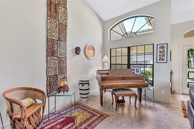 105 Inlets Blvd Unit 105, Nokomis, FL 34275 - living area with high vaulted ceiling, baseboards, and tile patterned flooring