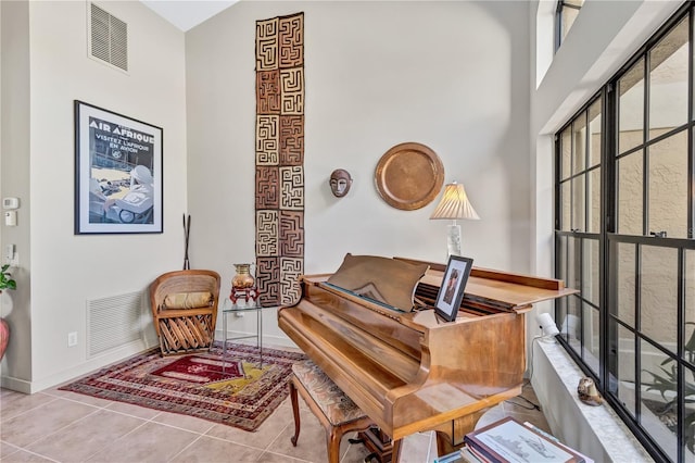 105 Inlets Blvd Unit 105, Nokomis, FL 34275 - living area featuring baseboards, tile patterned floors, and a high ceiling