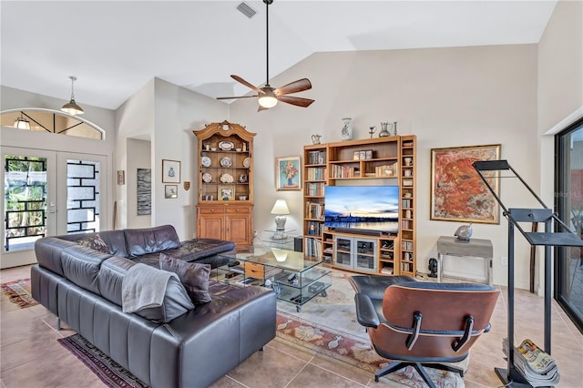 105 Inlets Blvd Unit 105, Nokomis, FL 34275 - living room with a ceiling fan, french doors, tile patterned flooring, and high vaulted ceiling