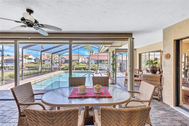 105 Inlets Blvd Unit 105, Nokomis, FL 34275 - sunroom / solarium featuring ceiling fan, a residential view, outdoor dining area, and a swimming pool