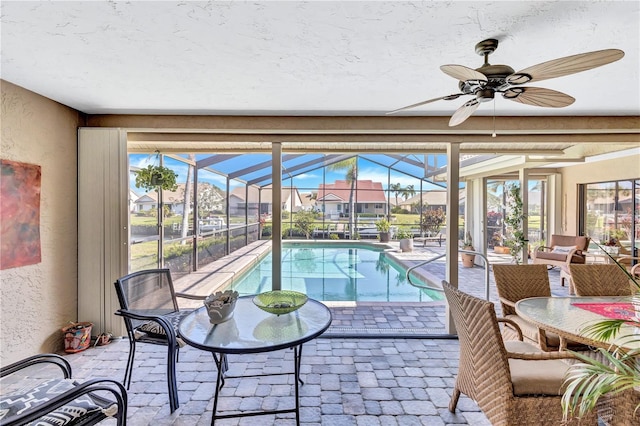 105 Inlets Blvd Unit 105, Nokomis, FL 34275 - sunroom / solarium featuring a pool, a ceiling fan, and a residential view