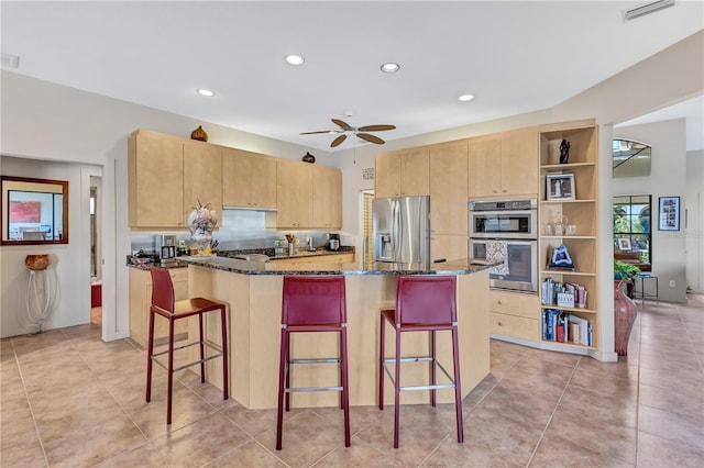 105 Inlets Blvd Unit 105, Nokomis, FL 34275 - kitchen with appliances with stainless steel finishes, open shelves, light brown cabinets, dark stone counters, and recessed lighting