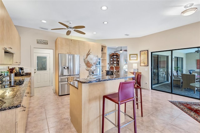 105 Inlets Blvd Unit 105, Nokomis, FL 34275 - kitchen featuring stainless steel appliances, ceiling fan, a breakfast bar area, light brown cabinetry, and recessed lighting