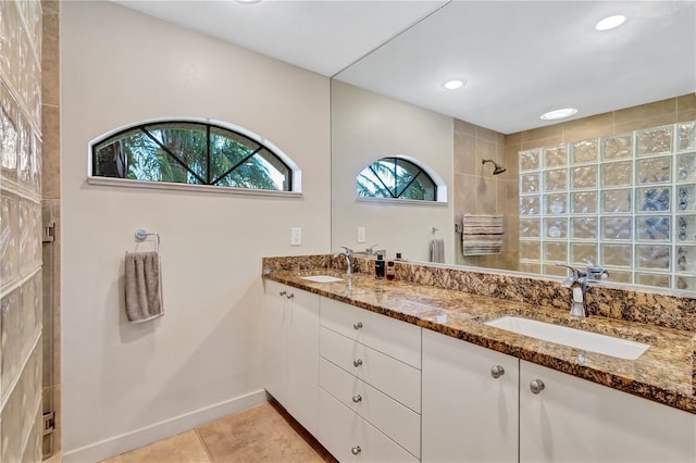 105 Inlets Blvd Unit 105, Nokomis, FL 34275 - full bathroom with a tile shower, double vanity, tile patterned flooring, baseboards, and recessed lighting