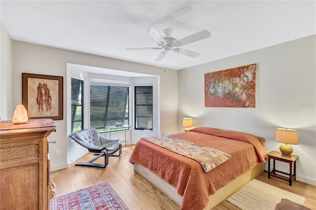 105 Inlets Blvd Unit 105, Nokomis, FL 34275 - bedroom with light wood-style flooring, baseboards, and a ceiling fan
