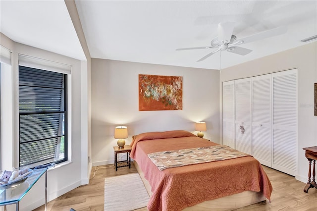 105 Inlets Blvd Unit 105, Nokomis, FL 34275 - bedroom with light wood-style flooring, baseboards, a closet, and a ceiling fan