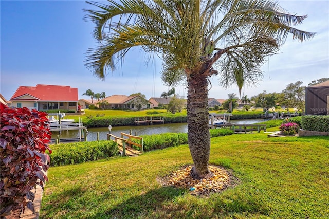 105 Inlets Blvd Unit 105, Nokomis, FL 34275 - view of grassy yard featuring a dock, a water view, a residential view, and boat lift