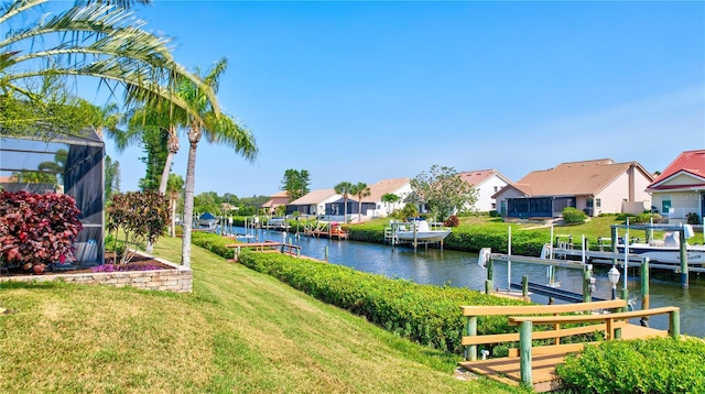 105 Inlets Blvd Unit 105, Nokomis, FL 34275 - dock featuring boat lift, a residential view, a water view, and a lawn