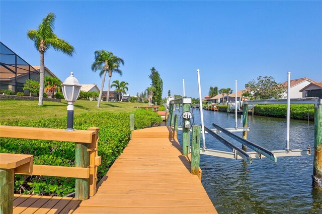 105 Inlets Blvd Unit 105, Nokomis, FL 34275 - dock with boat lift, a water view, and a lawn