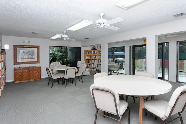 105 Inlets Blvd Unit 105, Nokomis, FL 34275 - dining room featuring a textured ceiling, a ceiling fan, and baseboards