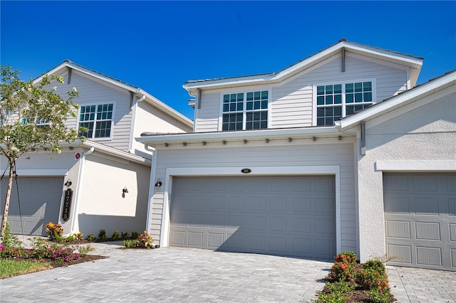 17715 Boracay Ct Unit 202, Venice, FL 34293 - view of front of home featuring an attached garage, decorative driveway, and stucco siding