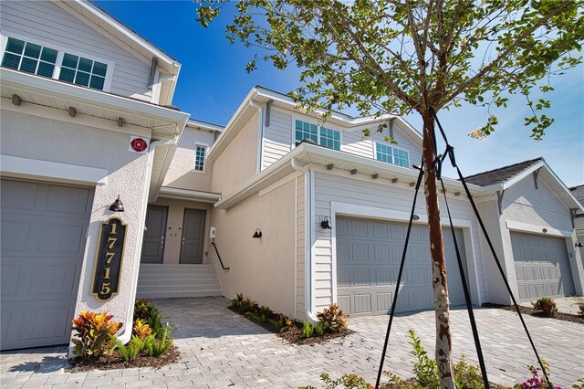 17715 Boracay Ct Unit 202, Venice, FL 34293 - view of front facade with a garage and stucco siding