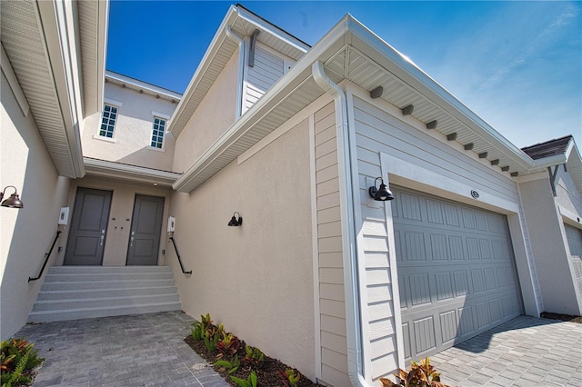 17715 Boracay Ct Unit 202, Venice, FL 34293 - view of exterior entry featuring a garage and stucco siding